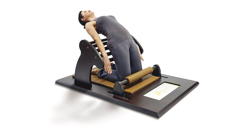 Frau macht Dehnübung auf Gerät